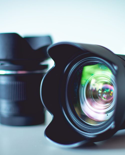 A closeup of a digital camera with lenses